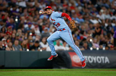 Nolan Arenado (28) attempts a throw to first base in the fourth inning against the Colorado Rockies at Coors Field. Mandatory Credit: Isaiah J. Downing-USA TODAY Sports