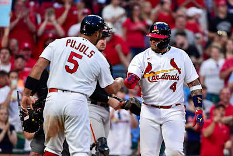 May 15, 2022; St. Louis, Missouri, USA; St. Louis Cardinals catcher Yadier Molina (4) celebrates with designated hitter Albert Pujols (5) after hitting a two run home run against the San Francisco Giants during the fifth inning at Busch Stadium. Mandatory Credit: Jeff Curry-USA TODAY Sports