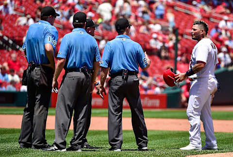 Jun 14, 2022; St. Louis, Missouri, USA; St. Louis Cardinals catcher Yadier Molina (4) talks with the umpire crew after he picked off by Pittsburgh Pirates starting pitcher JT Brubaker (not pictured) during the fourth inning at Busch Stadium. The call was overturned and a balk was issued to Brubaker. Mandatory Credit: Jeff Curry-USA TODAY Sports