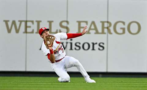 Jul 13, 2022; St. Louis, Missouri, USA; St. Louis Cardinals center fielder Dylan Carlson (3) slides and makes a catch against the Los Angeles Dodgers during the fourth inning at Busch Stadium. Mandatory Credit: Jeff Curry-USA TODAY Sports