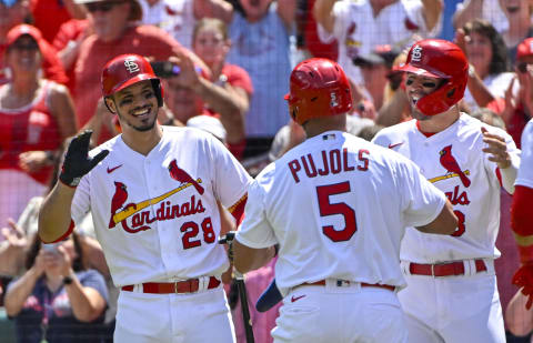 Aug 18, 2022; St. Louis, Missouri, USA; St. Louis Cardinals pinch hitter Albert Pujols (5) is congratulated by third baseman Nolan Arenado (28) and center fielder Dylan Carlson (3) after hitting a grand slam for his 690th career home run against the Colorado Rockies during the third inning at Busch Stadium. Mandatory Credit: Jeff Curry-USA TODAY Sports