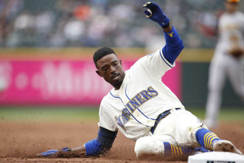 Jul 7, 2019; Seattle, WA, USA; Seattle Mariners second baseman Dee Gordon (9) slides safely into third base after hitting a triple against the Oakland Athletics during the third inning at T-Mobile Park. Mandatory Credit: Jennifer Buchanan-USA TODAY Sports