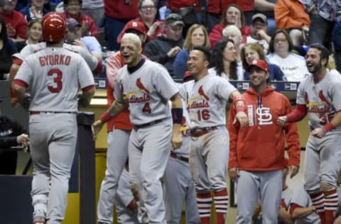 Apr 22, 2017; Milwaukee, WI, USA; St. Louis Cardinals second baseman Jedd Gyorko (3) is greeted by teammates after driving in a run with a triple and scoring on a throwing error in the ninth inning during the game against the Milwaukee Brewers at Miller Park. The Cardinal beat the Brewers 4-1. Mandatory Credit: Benny Sieu-USA TODAY Sports