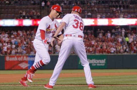 Jun 9, 2017; St. Louis, MO, USA; St. Louis Cardinals third base coach Mike Shildt (38) congratulates shortstop Aledmys Diaz (36) as he runs the bases after hitting a solo home run during the fifth inning against the Philadelphia Phillies at Busch Stadium. Mandatory Credit: Scott Kane-USA TODAY Sports