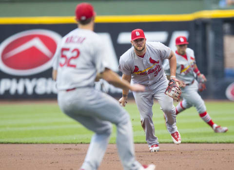 Jul 8, 2016; Milwaukee, WI, USA; St. Louis Cardinals first baseman Matt Adams (32) tosses the ball to pitcher Michael Wacha (52) during the first inning against the Milwaukee Brewers at Miller Park. Mandatory Credit: Jeff Hanisch-USA TODAY Sports