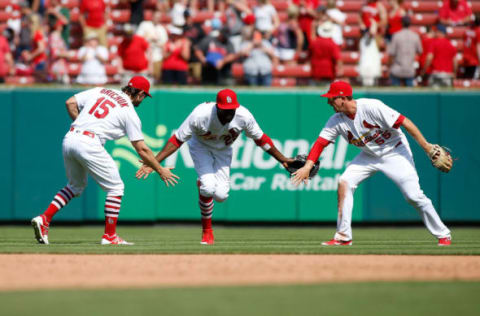 Apr 19, 2017; St. Louis, MO, USA; St. Louis Cardinals center fielder Dexter Fowler (center) celebrates with teammates Randal Grichuk (left) and Stephen Piscotty (right) after the Cardinals defeated the Pittsburgh Pirates 2-1 at Busch Stadium. Mandatory Credit: Scott Kane-USA TODAY Sports