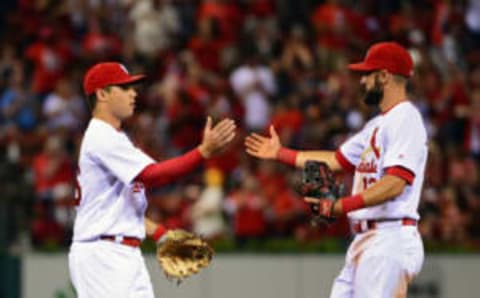 Jul 1, 2016; St. Louis, MO, USA; St. Louis Cardinals shortstop Aledmys Diaz (36) celebrates with second baseman Matt Carpenter (13) after defeating the Milwaukee Brewers at Busch Stadium. The Cardinals won 7-1. Mandatory Credit: Jeff Curry-USA TODAY Sports