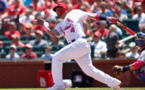 May 14, 2017; St. Louis, MO, USA; St. Louis Cardinals catcher Yadier Molina (4) follows through on a two-run home run during the second inning against the Chicago Cubs at Busch Stadium. Mandatory Credit: Scott Kane-USA TODAY Sports