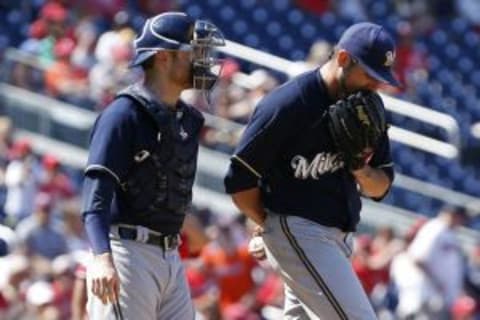 Aug 23, 2015; Washington, DC, USA; Milwaukee Brewers starting pitcher Matt Garza (22) talks with Brewers catcher Jonathan Lucroy (20) against the Washington Nationals in the fourth inning at Nationals Park. Mandatory Credit: Geoff Burke-USA TODAY Sports