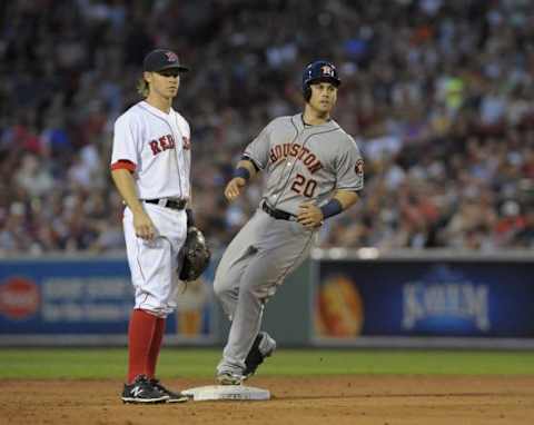 Jul 3, 2015; Boston, MA, USA; Houston Astros center fielder Alex Presley (20) takes second base after hitting an RBI double in the fourth inning as Boston Red Sox second baseman Brock Holt (26) watches at Fenway Park. Mandatory Credit: Bob DeChiara-USA TODAY Sports