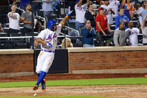 Sep 14, 2015; New York City, NY, USA; New York Mets center fielder Eric Young Jr. (1) gestures as he scores during the seventh inning against the Miami Marlins at Citi Field. Mandatory Credit: Anthony Gruppuso-USA TODAY Sports