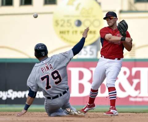 Mar 16, 2015; Jupiter, FL, USA; St. Louis Cardinals second baseman Jacob Wilson (87) turns a double play over Detroit Tigers catcher Manuel Pina (79) at Roger Dean Stadium. The Cardinals defeated the Tigers 1-0. Mandatory Credit: Scott Rovak-USA TODAY Sports