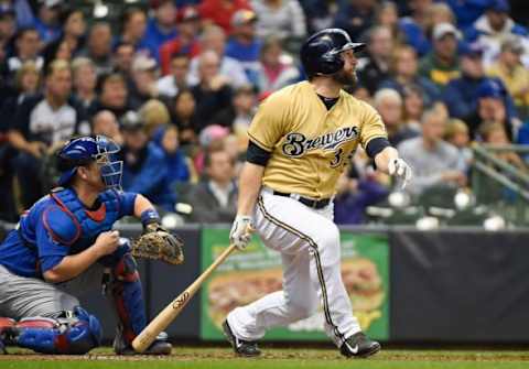 Oct 4, 2015; Milwaukee, WI, USA; Milwaukee Brewers right fielder Shane Peterson (35) hits a double to drive in a run in the third inning as Chicago Cubs catcher Miguel Montero (47) watches at Miller Park. Mandatory Credit: Benny Sieu-USA TODAY Sports