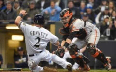 Apr 4, 2016; Milwaukee, WI, USA; San Francisco Giants catcher Buster Posey (28) tags out Milwaukee Brewers second baseman Scooter Gennett (2) trying to score on a hit by right fielder Domingo Santana (not pictured) in the fourth inning at Miller Park. Mandatory Credit: Benny Sieu-USA TODAY Sports