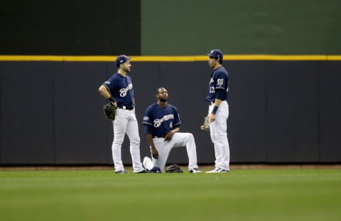 MILWAUKEE, WI – OCTOBER 05: (L-R) Ryan Braun #8, Lorenzo Cain #6, and Christian Yelich #22 of the Milwaukee Brewers meet in the outfield during a pitching change in the seventh inning of Game Two of the National League Division Series against the Colorado Rockies at Miller Park on October 5, 2018 in Milwaukee, Wisconsin. (Photo by Dylan Buell/Getty Images)