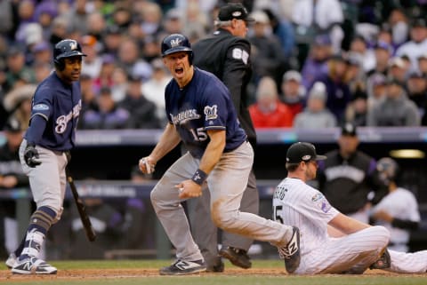 DENVER, CO – OCTOBER 07: Erik Kratz #15 of the Milwaukee Brewers celebrates near teammate Curtis Granderson #28 after scoring on a wild pitch by Scott Oberg #45 who reacts on home plate putting the Brewers up 4-0 in the sixth inning of Game Three of the National League Division Series against the Colorado Rockies at Coors Field on October 7, 2018 in Denver, Colorado. (Photo by Justin Edmonds/Getty Images)