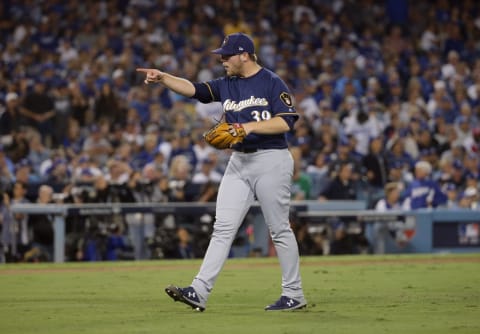 LOS ANGELES, CA – OCTOBER 16: Pitcher Corbin Burnes #39 of the Milwaukee Brewers reacts catcher Manny Pina #9 (not in photo) threw out Brian Dozier #6 of the Los Angeles Dodgers (not in photo) trying to steal second base to end the sixth inning of Game Four of the National League Championship Series against the Los Angeles Dodgers at Dodger Stadium on October 16, 2018 in Los Angeles, California. (Photo by Jeff Gross/Getty Images)