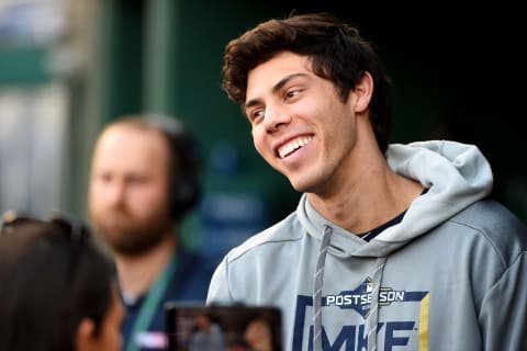 WASHINGTON, DC – OCTOBER 01: Christian Yelich #22 of the Milwaukee Brewers talks to the media in the dugout prior to the National League Wild Card game against the Washington Nationals at Nationals Park on October 01, 2019 in Washington, DC. (Photo by Will Newton/Getty Images)