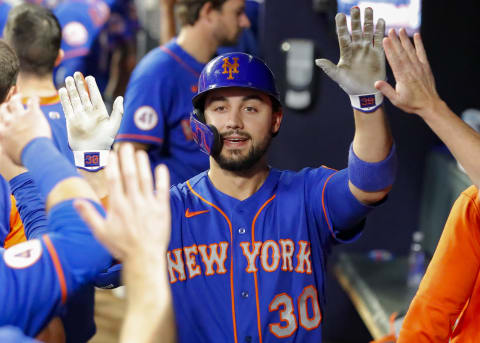 ATLANTA, GA – OCTOBER 02: Michael Conforto #30 of the New York Mets reacts with teammates after hitting a ball deep for a home run during the eighth inning of the game against the Atlanta Braves at Truist Park on October 2, 2021 in Atlanta, Georgia. (Photo by Todd Kirkland/Getty Images)