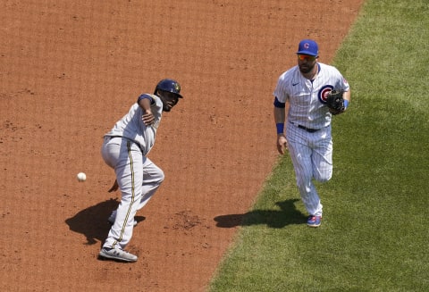 CHICAGO, ILLINOIS – JULY 25: Lorenzo Cain #6 of the Milwaukee Brewers avoids being tagged while being caught between the bases during the game against the Chicago Cubs at Wrigley Field on July 25, 2020 in Chicago, Illinois. The 2020 season had been postponed since March due to the COVID-19 pandemic. (Photo by Nuccio DiNuzzo/Getty Images)