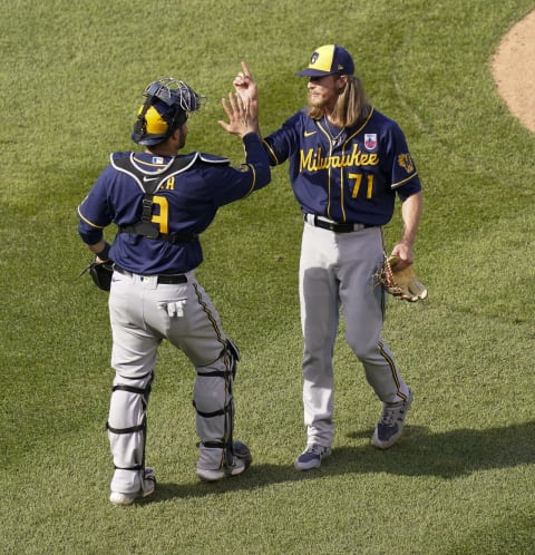 CHICAGO, ILLINOIS – AUGUST 16: Manny Pina #9 and Josh Hader #71 of the Milwaukee Brewers celebrate a 6-5 win over the Chicago Cubs at Wrigley Field on August 16, 2020 in Chicago, Illinois. (Photo by Nuccio DiNuzzo/Getty Images)