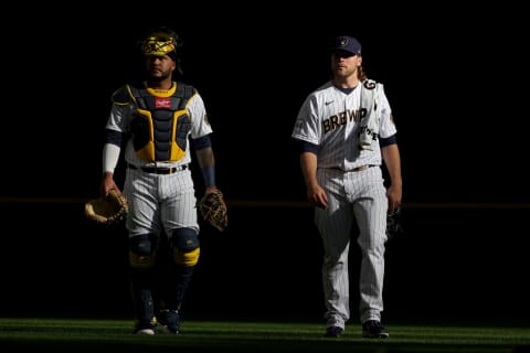 MILWAUKEE, WISCONSIN – OCTOBER 08: Corbin Burnes #39 and Omar Narvaez #10 of the Milwaukee Brewers walk to the dugout prior to game 1 of the National League Division Series against the Atlanta Braves at American Family Field on October 08, 2021 in Milwaukee, Wisconsin. (Photo by Stacy Revere/Getty Images)