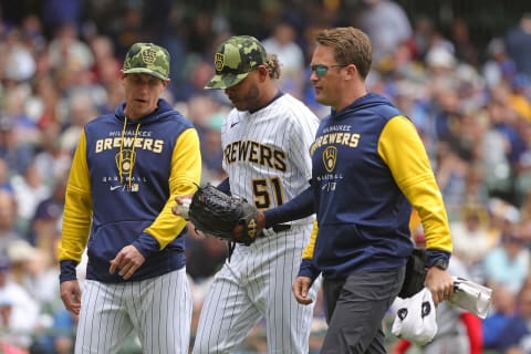 MILWAUKEE, WISCONSIN – MAY 22: Manager Craig Counsell #30 of the Milwaukee Brewers walks with Freddy Peralta #51 as he leaves the game during the fourth inning against the Washington Nationals at American Family Field on May 22, 2022 in Milwaukee, Wisconsin. (Photo by Stacy Revere/Getty Images)