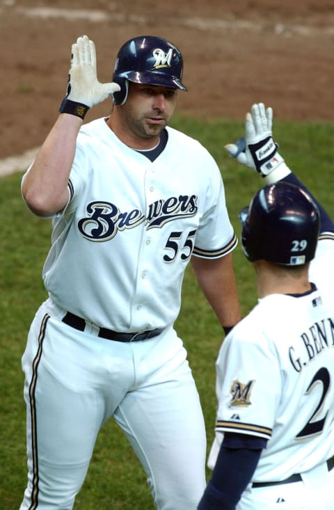 MILWAUKEE – APRIL 22: Pinch hitter Brooks Kieschnick #55 of the Milwaukee Brewers is congratulated by teammate Gary Bennett after hitting a two-run home run in the ninth inning tying the Arizona Diamondbacks April 22, 2004 at Miller Park in Milwaukee, Wisconsin. The Diamondbacks defeated the Brewers 11-9 in 15 innings. (Photo by Jonathan Daniel/Getty Images)