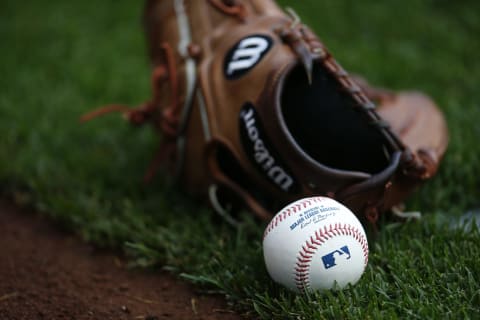 MILWAUKEE, WI – SEPTEMBER 03: A Wilson baseball glove and major league baseballs sits on the field at Miller Park on September 3, 2015 in Milwaukee, Wisconsin. (Photo by Jeff Haynes/Getty Images)