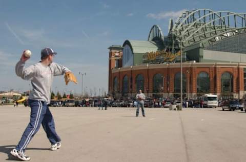 MILWAUKEE, WI – APRIL 9: Mark Notz of Des Moines, Iowa plays catch in the parking lot of Miller Park with friend Phil Kaplan before the opening day game between the Milwaukee Brewers and the Houston Astros on April 9, 2004 at Miller Park in Milwaukee, Wisconsin. (Photo by Jonathan Daniel/Getty Images)