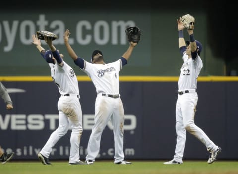 Oct 19, 2018; Milwaukee, WI, USA;Milwaukee Brewers left fielder Ryan Braun (8) and center fielder Lorenzo Cain (6) and right fielder Christian Yelich (22) celebrate after defeating the Los Angeles Dodgers in game six of the 2018 NLCS playoff baseball series at Miller Park. Mandatory Credit: Jon Durr-USA TODAY Sports