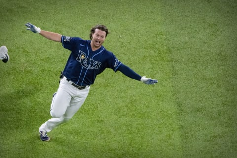 Oct 24, 2020; Arlington, Texas, USA; Tampa Bay Rays right fielder Brett Phillips (14) celebrates hitting a walk off two run single against the Los Angeles Dodgers during the ninth inning in game four of the 2020 World Series at Globe Life Field. Mandatory Credit: Jerome Miron-USA TODAY Sports