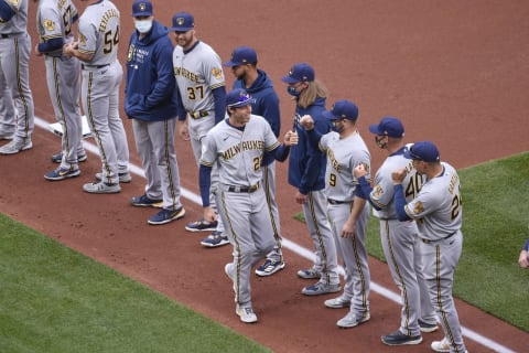 Apr 8, 2021; St. Louis, Missouri, USA; Milwaukee Brewers left fielder Christian Yelich (22) high fives teammates after being introduced during an opening day ceremony prior to a game against the St. Louis Cardinals at Busch Stadium. Mandatory Credit: Joe Puetz-USA TODAY Sports