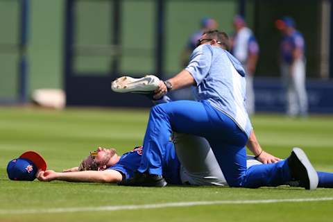 WEST PALM BEACH, FL – MARCH 11: Pete Alonso #20 of the New York Mets has his leg stretched out by a member of the training staff before a spring training baseball game against the Houston Astros at Fitteam Ballpark of the Palm Beaches on March 11, 2019 in West Palm Beach, Florida. The Astros defeated the Mets 6-3. (Photo by Rich Schultz/Getty Images)