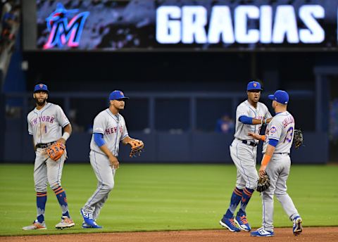 MIAMI, FL – APRIL 03: (L-R) Amed Rosario, Juan Lagares #12, Keon Broxton #23, and Luis Guillorme #13 of the New York Mets celebrate the win against the Miami Marlins at Marlins Park on April 3, 2019 in Miami, Florida. (Photo by Mark Brown/Getty Images)