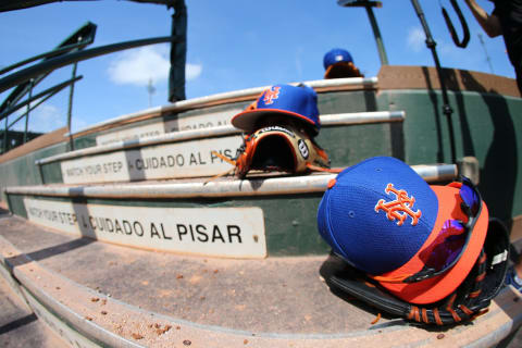 JUPITER, FL – MARCH 12: New Era caps and Wilson gloves of the New York Mets sit on the dugout steps during a spring training baseball game against the Miami Marlins at Roger Dean Stadium on March 12, 2019 in Jupiter, Florida. The Marlins defeated the Mets 8-1. (Photo by Rich Schultz/Getty Images)