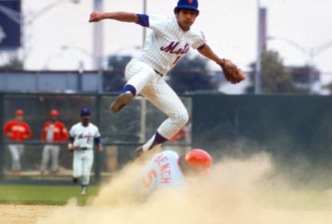 NEW YORK – CIRCA 1975: Felix Millan #17 of the New York Mets gets his throw off to first base while leaping over the sliding Johnny Bench #5 of the Cincinnati Reds during an Major League Baseball game circa 1975 at Shea Stadium in the Queens borough of New York City. Millan played for Mets from 1973-77. (Photo by Focus on Sport/Getty Images)