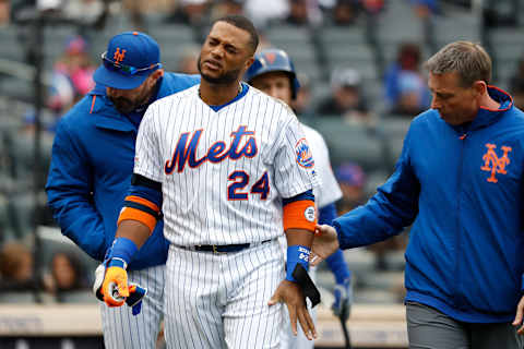 NEW YORK, NEW YORK – APRIL 28: Robinson Cano #24 of the New York Mets reacts after getting hit on a foul tip in the first inning against the Milwaukee Brewers at Citi Field on April 28, 2019 in the Flushing neighborhood of the Queens borough of New York City. (Photo by Michael Owens/Getty Images)