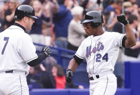 New York Mets leftfielder Rickey Henderson (R) and catcher Todd Pratt (L) celebrate Henderson’s scoring the go ahead run on a double by Benny Agbayani in the bottom of the sixth inning of game four of the National League Division Series at Shea Stadium in Flushing, NY. The Mets have a 2-1 lead in the best-of-five series. (ELECTRONIC IMAGE) AFP PHOTO/Timothy A. CLARY (Photo by Timothy A. CLARY / AFP) (Photo credit should read TIMOTHY A. CLARY/AFP via Getty Images)