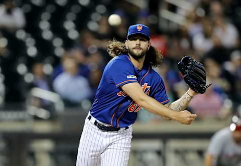 NEW YORK, NEW YORK – MAY 20: Robert Gsellman #65 of the New York Mets tries to pick off the runner at first in the eighth inning against the Washington Nationals at Citi Field on May 20, 2019 in the Flushing neighborhood of the Queens borough of New York City. (Photo by Elsa/Getty Images)