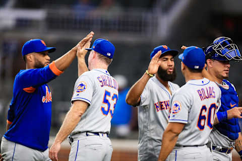 ATLANTA, GA – AUGUST 15: Glenn Sherlock #53, Luis Rojas #60, Wilson Ramos #40, and Amed Rosario #1 of the New York Mets shake hands following their 10-8 win over the Atlanta Braves at SunTrust Park on August 15, 2019 in Atlanta, Georgia. (Photo by Carmen Mandato/Getty Images)