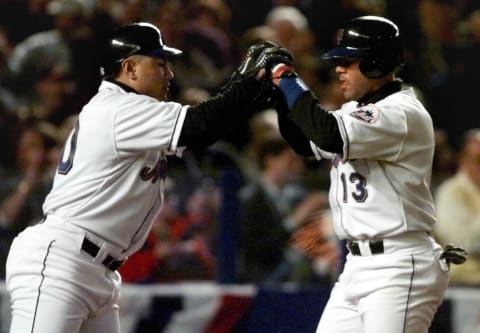 New York Mets’ right fielder Benny Agbayani (L) congratulates Edgardo Alfonso (R) after he scored on a base hit by John Olerud in the third inning 08 October against the Arizona Diamondbacks in game three of the National League Division Series at Shea Stadium in Flushing, NY. The best-of-five series is tied 1-1. (ELECTRONIC IMAGE) AFP PHOTO/Timothy A. CLARY (Photo by Timothy A. CLARY / AFP) (Photo by TIMOTHY A. CLARY/AFP via Getty Images)