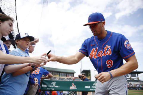 JUPITER, FLORIDA – MARCH 09: Brandon Nimmo #9 of the New York Mets signs a autograph for a fan against the Miami Marlins during a Grapefruit League spring training game at Roger Dean Stadium on March 09, 2020 in Jupiter, Florida. (Photo by Michael Reaves/Getty Images)