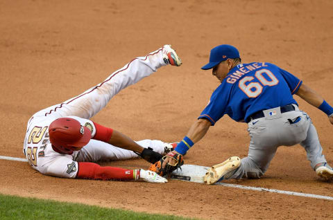 WASHINGTON, DC – AUGUST 05: Juan Soto #22 of the Washington Nationals is tagged out at third base in the fourth inning by Andres Gimenez #60 of the New York Mets at Nationals Park on August 5, 2020 in Washington, DC. (Photo by Greg Fiume/Getty Images)