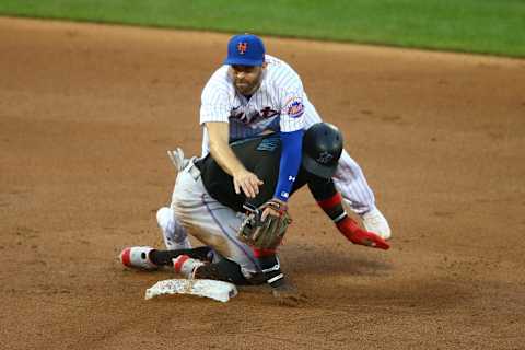 NEW YORK, NEW YORK – AUGUST 08: Brian Dozier #15 of the New York Mets falls over Monte Harrison #4 of the Miami Marlins to complete a double play in the second inning at Citi Field on August 08, 2020 in New York City. (Photo by Mike Stobe/Getty Images)