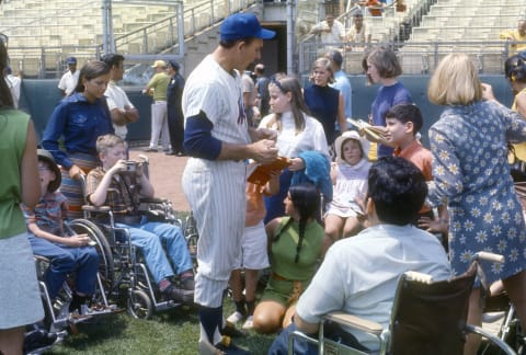 NEW YORK – CIRCA 1969: Manager Gil Hodges #14 of the New York Mets signing autographs for fans prior to the start of a Major League Baseball game circa 1969 at Shea Stadium in the Queens borough of New York City. Hodges managed the Mets from 1968-71. (Photo by Focus on Sport/Getty Images)