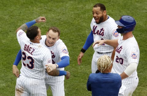 NEW YORK, NEW YORK – AUGUST 31: Javier Baez #23 of the New York Mets celebrates after scoring the winning run in the ninth inning against the Miami Marlins with teammates Brandon Nimmo #9, Dominic Smith #2 and Pete Alonso #20 at Citi Field on August 31, 2021 in New York City. This is a continuation of the April 11 game which was suspended due to inclement weather. The Mets defeated the Marlins 6-5. (Photo by Jim McIsaac/Getty Images)