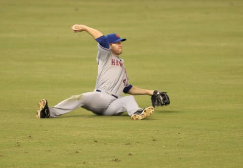 MIAMI, FL – SEPTEMBER 02: Outfielder Jason Bay #44 of the New York Mets throws the ball after missing a catch against the Miami Marlins at Marlins Park on September 2, 2012 in Miami, Florida. (Photo by Marc Serota/Getty Images)