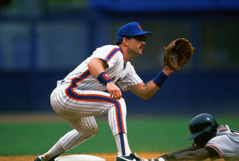 NEW YORK – CIRCA 1989: Howard Johnson #20 of the New York Mets sets to take the throw at third base against the San Francisco Giants during an Major League Baseball game circa 1989 at Shea Stadium in the Queens borough of New York City. Johnson played for the Mets from 1985-93. (Photo by Focus on Sport/Getty Images)