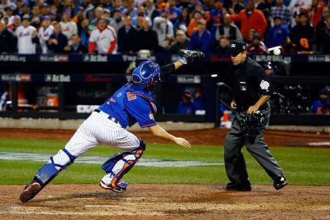 NEW YORK, NY – NOVEMBER 01: Travis d’Arnaud #7 of the New York Mets fails to make the play on a ball overthrown by Lucas Duda #21 of the New York Mets (not pictured) in the ninth inning against the Kansas City Royals during Game Five of the 2015 World Series at Citi Field on November 1, 2015 in the Flushing neighborhood of the Queens borough of New York City. Eric Hosmer #35 of the Kansas City Royals (not pictured) would score. (Photo by Al Bello/Getty Images)